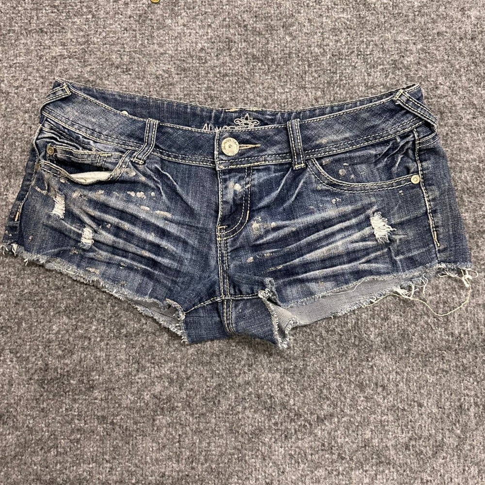 Almost Famous Shorts Womens Size 7 Blue Distressed Denim Low Rise Raw Hem Splat